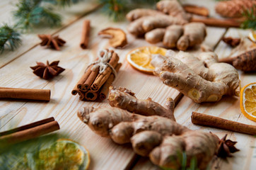 Christmas background with new year decorations and traditional spices ginger, dried oranges and apples, cinnamon sticks, anise stars. Ingredients for cooking or mulled wine. Christmas new year bakery