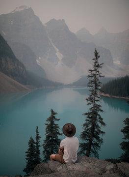 Rear view of man sitting on rock in Canada