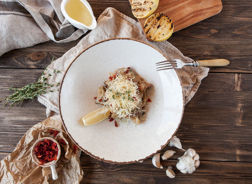 salad with rapans and sun-dried tomatoes under parmesan on a wooden table
