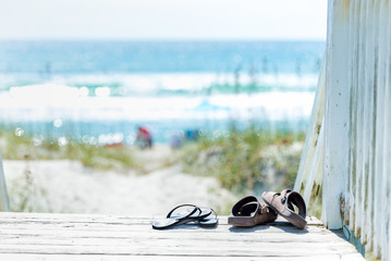 Sandals on the boardwalk by the beach - 185294059