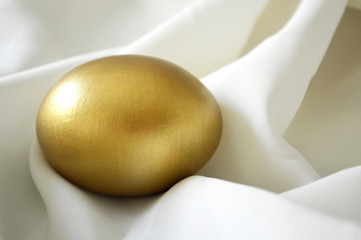 Easter egg on white silk background
