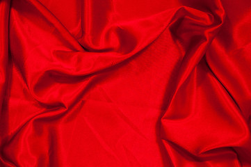 Smooth elegant red silk or satin luxury cloth texture can use as abstract background. Luxurious valentines day background design