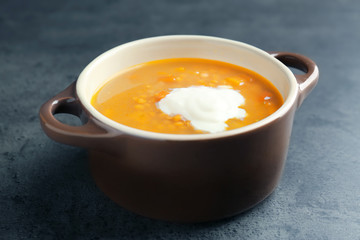 Dish with tasty lentil soup on table