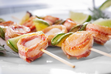 Plate with bacon wrapped scallops, closeup