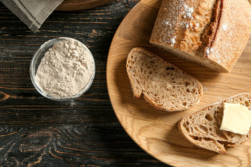 Fototapeta na wymiar Wooden plate with buckwheat bread on table