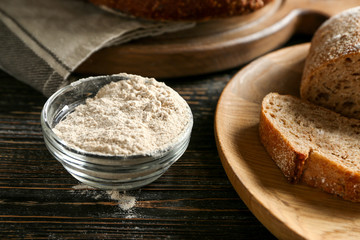 Glass bowl with buckwheat flour on table
