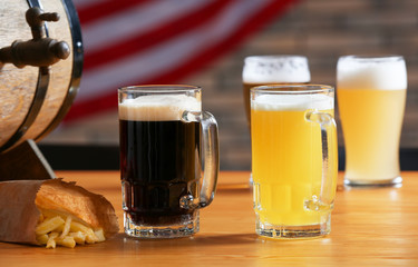 Glasses with dark and light beer on table in sport bar