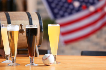 Glasses with different sorts of beer on table in sport bar