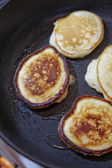 Sweet pancakes are fried in a frying pan. Home kitchen. Preparation of homemade food