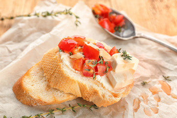 Tasty bruschetta with tomatoes on table, closeup