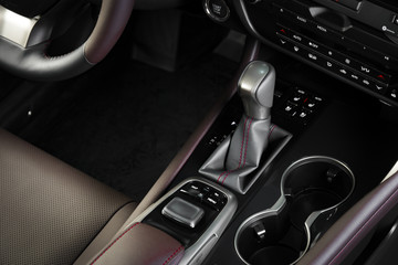 Automatic transmission gear shift of a modern car, car interior details with electronic components,...