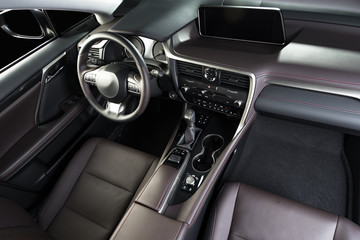 Modern luxury car  interior, dashboard, steering wheel. Red perforated  leather interior