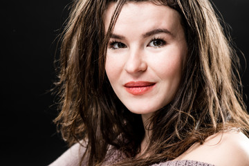 Naklejka premium Portrait of beautiful young woman on black background
