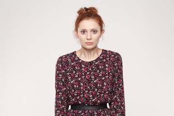  Portrait of unhappy and depressed woman with ginger hair feeling ashamed or sick, covering face with both hands, keeping eyes closed.