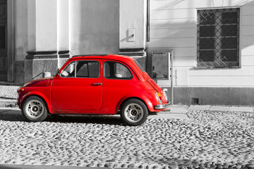 Red vintage italian car on black and white background - obrazy, fototapety, plakaty