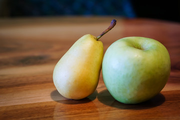 Fresh pear and apple on wooden table
