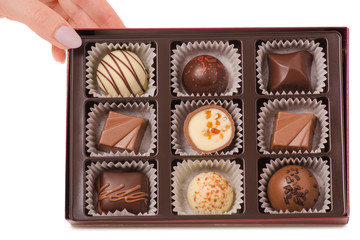 The box chocolate candies female hand