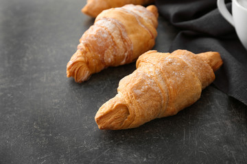 Tasty croissants on dark background