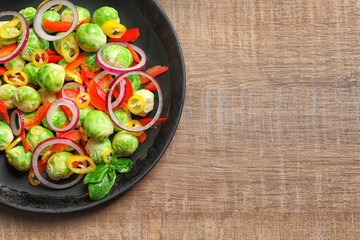 Plate with yummy brussel sprouts salad on table