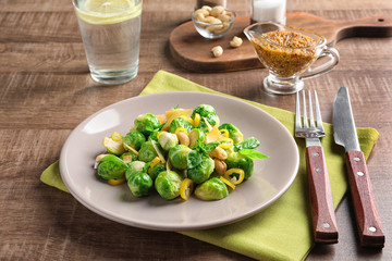 Plate with yummy brussel sprouts salad on table