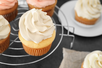 Tasty cupcakes on cooling rack