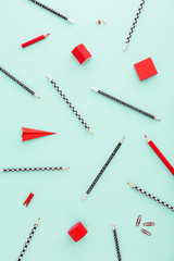 School stationery pencils, crayons, rubber, sticky note in a red color on pastel blue background with copy space