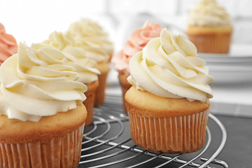Tasty cupcakes on cooling rack