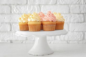 Tasty cupcakes on stand