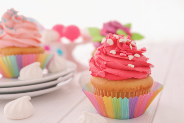 Tasty colorful cupcake on table