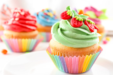 Tasty colorful cupcake on table