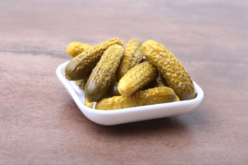 Pickles. Bowl of pickled gherkins cucumber with copy space. Cornichons.