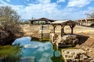 Authentic site of Jesus' baptism under blue skies with fluffy cl