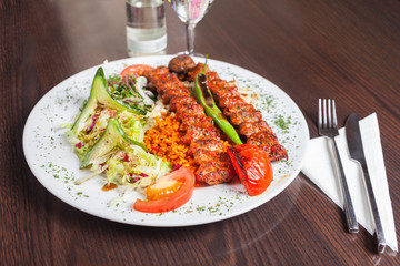 Adana kebap with rice and vegetables