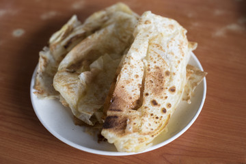 flatbrea on a table. malaysian famous meal called ROTI CANAI