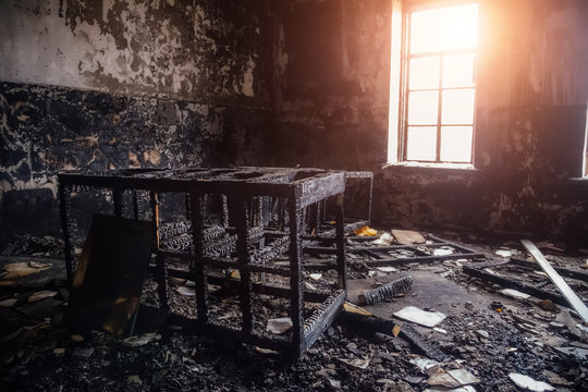 Burned room interior in apartment house. Burned furniture and charred walls in black soot