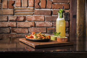 Tasty burger with fries and a cold alcoholic drink