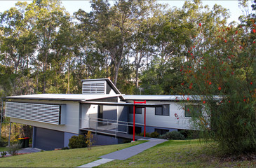 Modern style subtropical suburban home near Brisbane Australia with tall gum trees behind