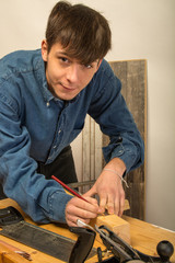 young man working on wood
