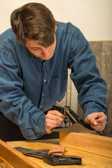 young man working on wood