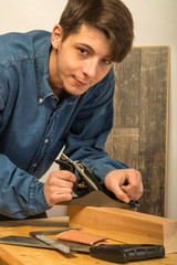 young man working on wood