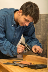 Fototapeta na wymiar young man working on wood