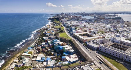 Fototapeten Aerial view of old San Juan, Puerto Rico and La Perla slum. © Wollwerth Imagery
