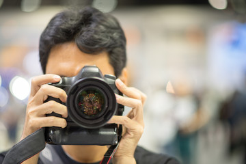 Young male tourist taking photo indoor