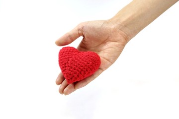 Woman hand giving red crocheted heart. Valentine's Day. Symbol of love.