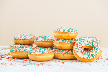 Donuts with white chocolate cream and sprinkles sugar