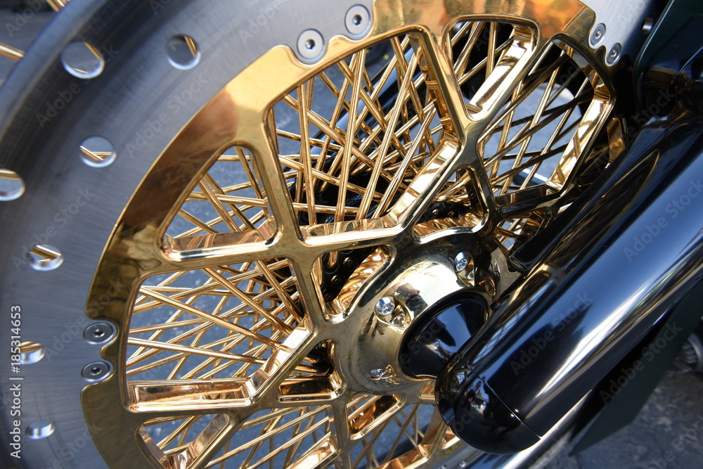 Wall mural chopper motorcycle front wheel and hub with shiny gold spokes