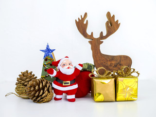Christmas tree decoration items on white background, Santa Claus with gift box and wooden reindeer, pine cone and wooden christmas tree