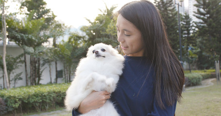 Young Woman being with her dog in the park