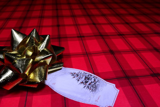 Red Christmas Wrapping Paper With Tag And Gold Bow. View 2