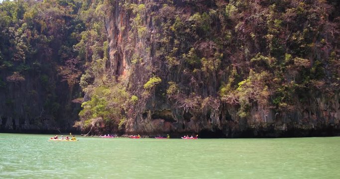 PHUKET, THAILAND, MARCH 2017:  Padling in small boats, through caves and alleys in Phi Phi Islands